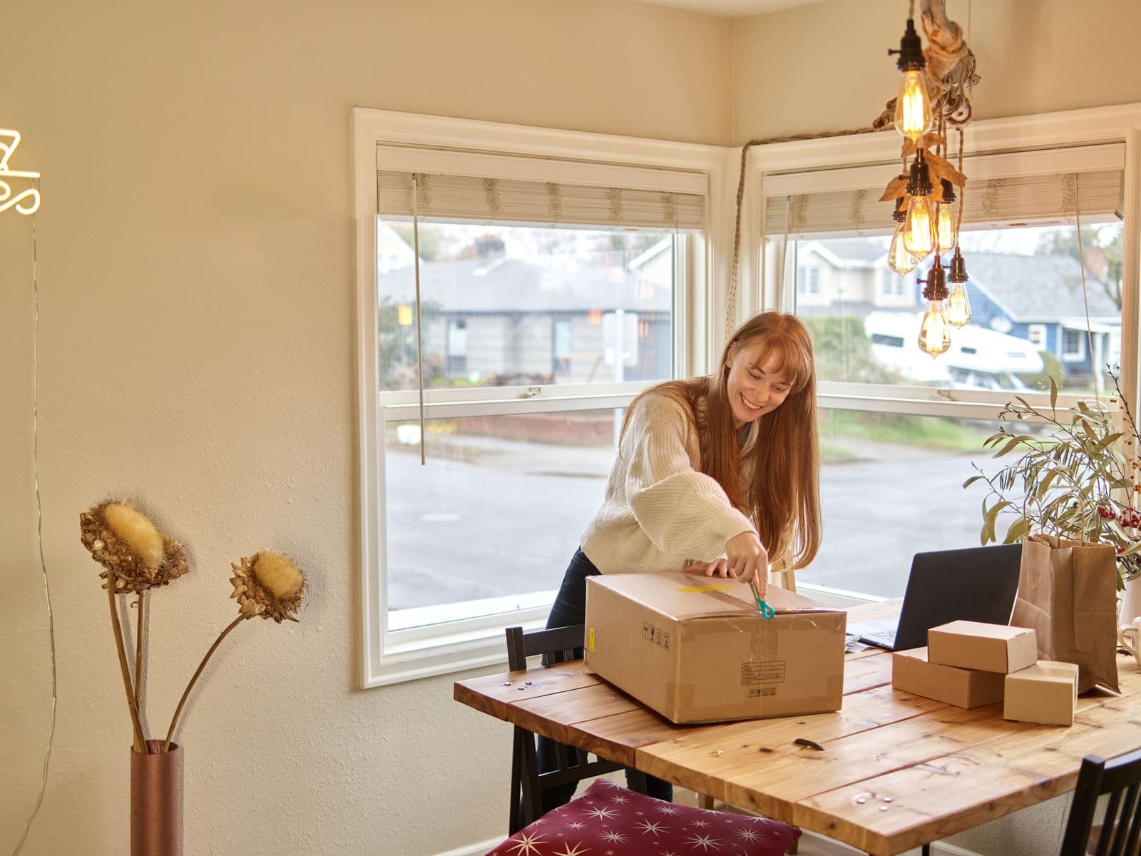 Une commerçante prépare des colis de commandes dans sa boutique lumineuse